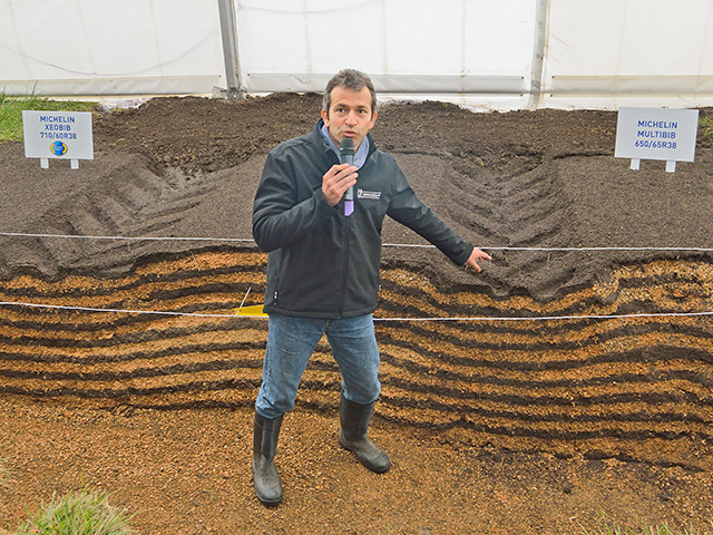 A Michelin engineer points out the compaction difference caused by a tire inflated to 22 psi (left) and one inflated to 12 psi. (Progressive Farmer photo by Jim Patrico)